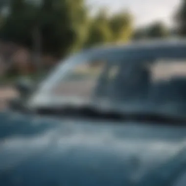 A close-up view of a cracked car windshield highlighting potential damage.